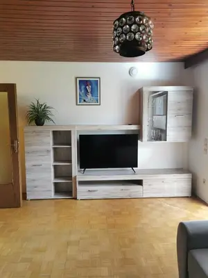 a living room with a large entertainment center with a flat screen tv at APARTMA MARUŠA in Bled