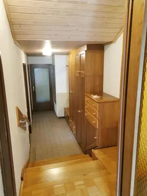 a hallway with a dresser and a cabinet in a room at APARTMA MARUŠA in Bled