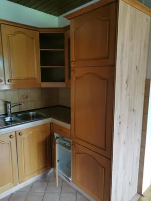a small kitchen with wooden cabinets and a sink at APARTMA MARUŠA in Bled