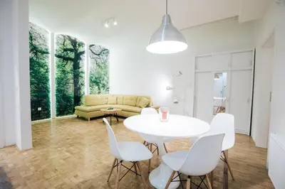 a living room with a table and chairs and a couch at Apartment Center II - Kersnikova in Ljubljana
