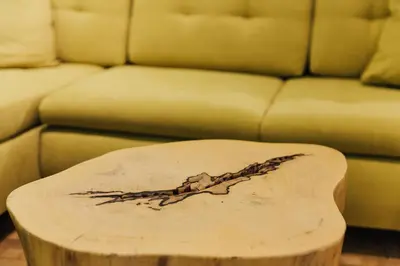 a wooden coffee table in front of a couch at Apartment Center II - Kersnikova in Ljubljana
