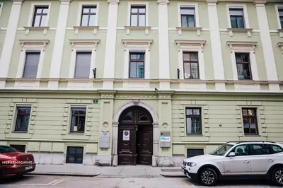 a white car parked in front of a building at Apartment Center II - Kersnikova in Ljubljana