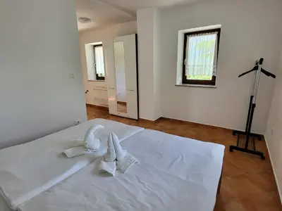 a bedroom with a white bed with towels on it at Holiday Home Belka with Terrace&BBQ in Tolmin