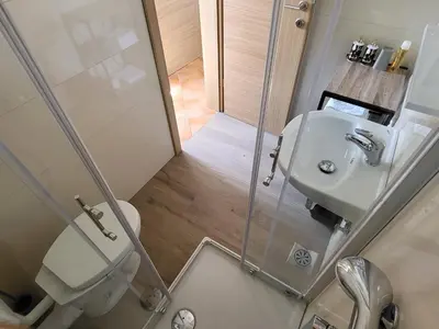 a small bathroom with a toilet and a sink at Holiday Home Belka with Terrace&BBQ in Tolmin