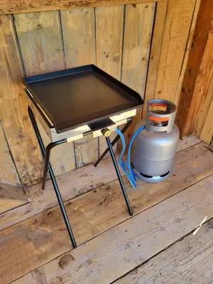 a small stove with a pot on a wooden floor at Holiday Home Belka with Terrace&BBQ in Tolmin