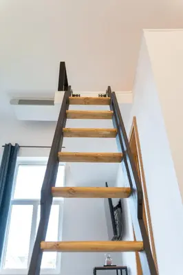 a wooden staircase in a house with a window at Apartment TRG in Brežice