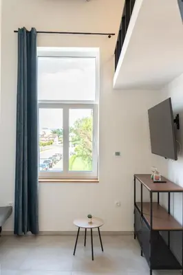 a living room with a window and a table at Apartment TRG in Brežice