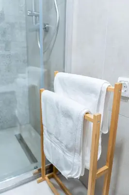 a towel chair in a bathroom with a shower at Apartment TRG in Brežice