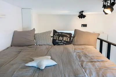 a white pillow on a bed in a room at Apartment TRG in Brežice