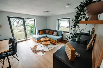 a living room with a couch and a table at Goat's Paradise in Bohinj