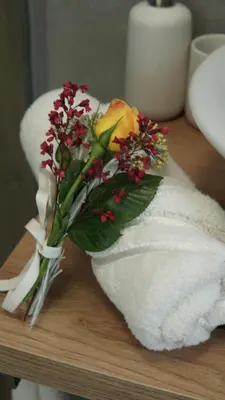 a bouquet of flowers sitting on top of a towel at Apartma Relax in Prestranek
