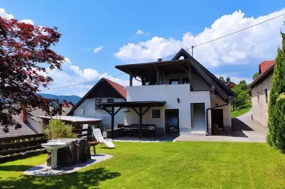 a white house with a lawn in front of it at MaLu apartment in nature with terrace in Jakovica