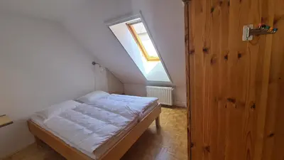 a small bedroom with a bed and a window at MaLu apartment in nature with terrace in Jakovica