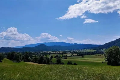 a view of a green field with mountains in the background at MaLu apartment in nature with terrace in Jakovica