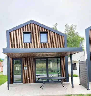 a house with a picnic table in front of it at ARIA DELUXE Mobile Homes with Terme Čatež Tickets in Čatež ob Savi