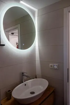 a bathroom with a white sink and a mirror at ARIA DELUXE Mobile Homes with Terme Čatež Tickets in Čatež ob Savi