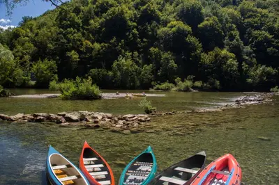 a group of kayaks are lined up on a river at BIG BERRY Kolpa - Isabella Premium House in Gradac