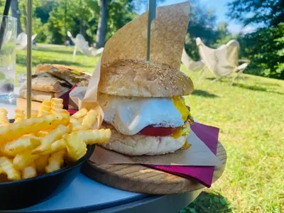 a sandwich and fries on a table with a bowl of fries at BIG BERRY Kolpa - Isabella Premium House in Gradac