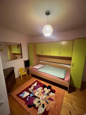 a bedroom with a bed and a rug with cows on it at Apartment GREEN HOUSE in Šempas