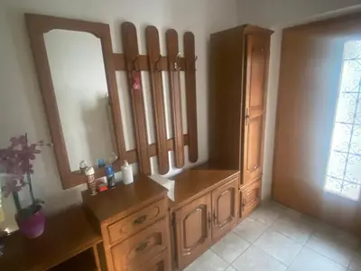 a bathroom with a wooden dresser and a mirror at Apartment GREEN HOUSE in Šempas