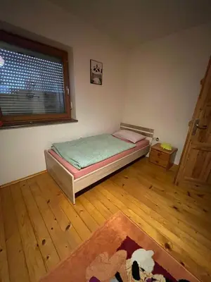 a small bedroom with a bed and a window at Apartment GREEN HOUSE in Šempas