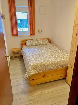 a bedroom with a bed and a window at Apartma EMI in Bovec