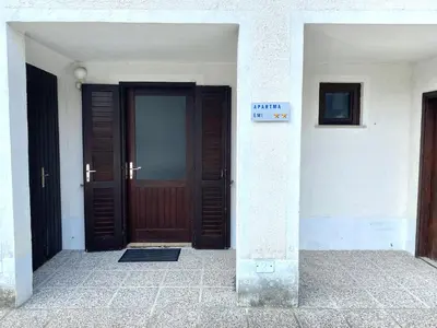 a front door of a building with a sign on it at Apartma EMI in Bovec