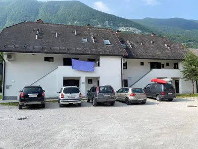 a group of cars parked in front of a building at Apartma EMI in Bovec