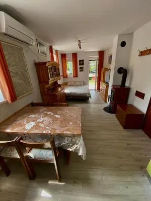 a living room with a table and a couch at Apartma EMI in Bovec