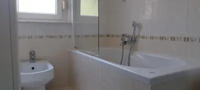 a bathroom with a tub and a toilet and a sink at 7 Flower Street Apartment in Šempeter pri Gorici