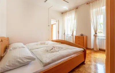 a bedroom with a bed with two white towels on it at Amazing Home In Podgorje in Podgorje