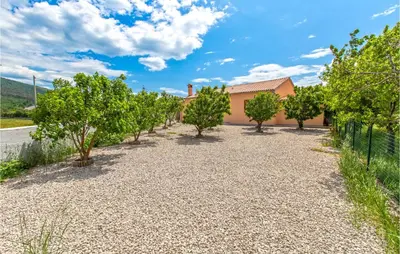 a driveway with trees in front of a house at Amazing Home In Podgorje in Podgorje
