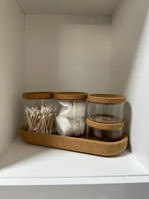 a shelf with two glass containers and a glass jar of items at Granny's Vintage Chic in Maribor