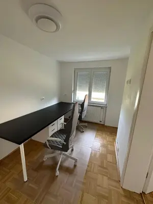 an office with a black desk and two chairs at Granny's Vintage Chic in Maribor