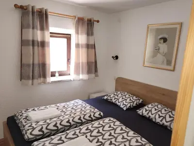 a bedroom with two beds and a window at Spring rest in Bled