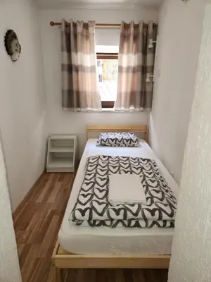 a small room with a bed and a window at Spring rest in Bled
