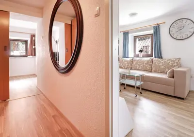 a living room with a couch and a mirror at Spring rest in Bled