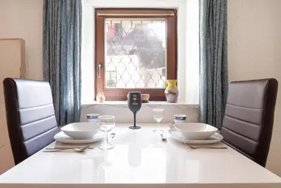 a white table with two chairs and a window at Spring rest in Bled