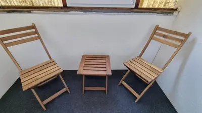 two wooden chairs and a table in a room at PARIS in Ljubljana