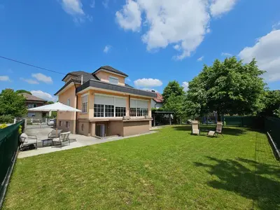 a large house with a yard with chairs at Apartma FIREFLY2 in Ljubljana