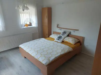 a bedroom with a bed with a robot on it at Apartma Vida in Videm pri Ptuju