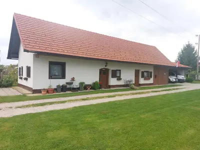 a small white house with a red roof at Apartma Vida in Videm pri Ptuju