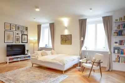 a living room with a bed and a tv at Stylish Apartment in Historical Center in Ljubljana