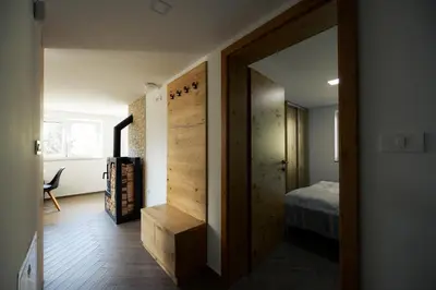 a room with a door leading to a bedroom at Holiday House Chilly in Kotlje
