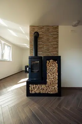 a fireplace with a pile of fire wood at Holiday House Chilly in Kotlje