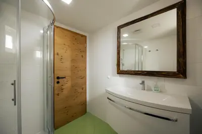 a bathroom with a sink and a mirror at Holiday House Chilly in Kotlje