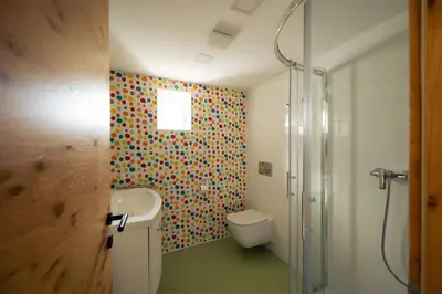 a bathroom with a toilet and a sink and a shower at Holiday House Chilly in Kotlje