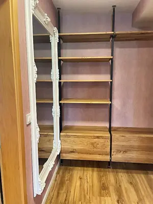 a closet with wooden shelves and a mirror at Vila Urbana Luxury Apartments in Lesce