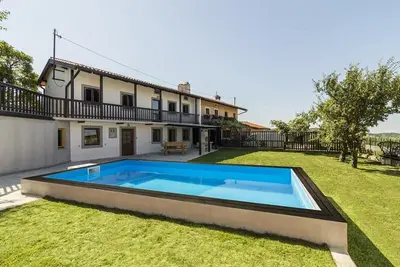 a large swimming pool in the yard of a house at Vila Sistiana in Kostanjevica na Krasu