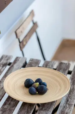 a plate of fruit on a wooden table at Vila Sistiana in Kostanjevica na Krasu
